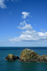 Fototapeta premium Rocky Coast Under Fluffy Clouds, Pembrokeshire, Wales, UK .