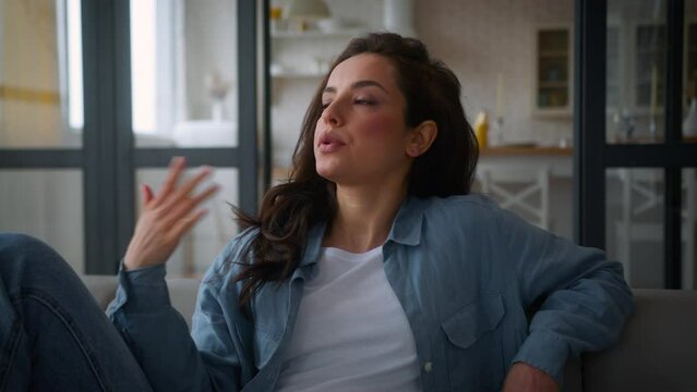 Caucasian suffer woman on sofa couch home girl female waving hands refresh cooling hot high air temperature broken conditioner summer reduce heat climate control system discomfort hormonal imbalance