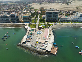 Aerial view of the fishing terminal in Ancón, Lima, Peru, showcasing the pier, fishing boats,...