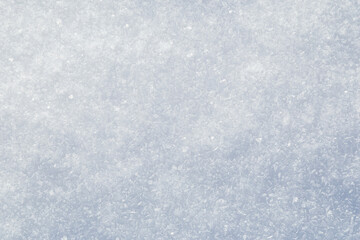 Close-up of fresh and bright snowy land in the winter, viewed from above. Abstract full frame textured background with copy space. Top view.