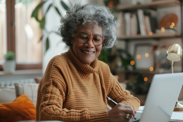 Senior African American Woman Working on Laptop. Modern Elderly Professional in Home Office. Concept of active life of retired, pensioner using technology