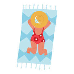 Young Child, Dressed In Swimsuit And A Large Sunhat, Sunbathing On A Beach Towel On A Sandy Beach Under The Sun