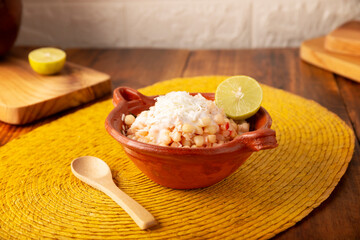 Esquites. Corn kernels cooked and served with mayo, sour cream, lemon and chili powder, very popular street food in Mexico, also known as Elote en Vaso. The recipe varies depending on the region.