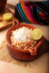 Esquites. Corn kernels cooked and served with mayo, sour cream, lemon and chili powder, very popular street food in Mexico, also known as Elote en Vaso. The recipe varies depending on the region.