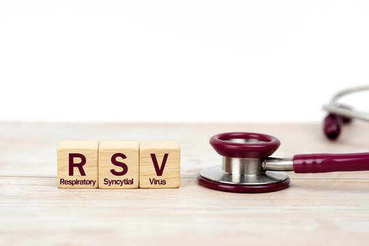 Word Respiratory Syncytial Virus (RSV) on wooden blocks and stethoscope on the wooden table with white background for copy space. Medical diagnosis and investigation technology concept.