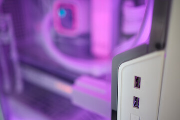 A close up of a computer with a blue light illuminating it