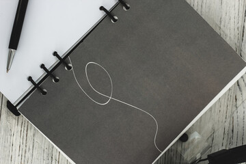 Notepad diary with pen on the desktop