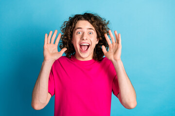Portrait of eccentric man with curly hairstyle piercing wear pink shirt raising palm up open mouth...