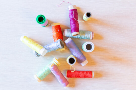 Colorful spools of thread on a wooden background