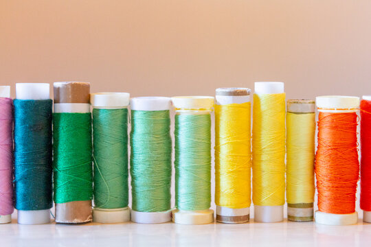Colorful sewing thread spools on a table