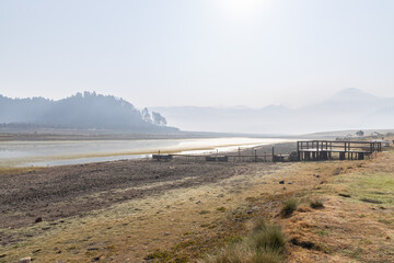 Pier over a dry lake swamp, global warming effect