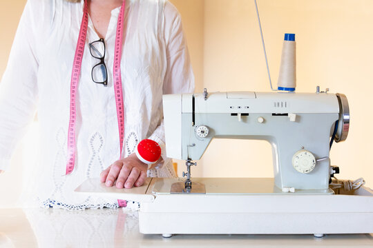 Tailor at Sewing Machine in Bright Workshop