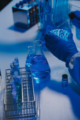 chemist,scientist hand dropping chemical liquid into test tube, science research and development concept