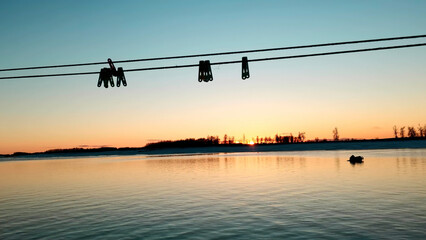 Beautiful sunset and blue sky over a forest lake at evening. Clip. Gentle lake ripples and ropes...