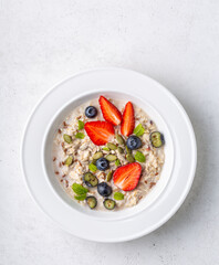 Nutritious porridge with seeds and berries, overhead shot