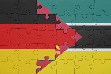 puzzle with the colourful national flag of mozambique and flag of germany.