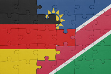 puzzle with the colourful national flag of namibia and flag of germany.