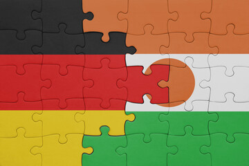 puzzle with the colourful national flag of niger and flag of germany.