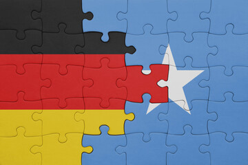 puzzle with the colourful national flag of somalia and flag of germany.