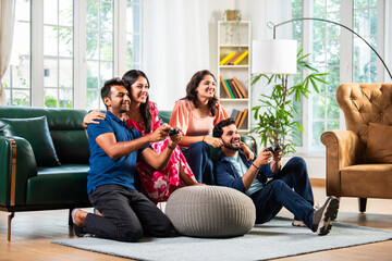 Four indian asian young Indian asian couple friends playing video game at home