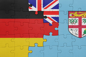 puzzle with the colourful national flag of Fiji and flag of germany.
