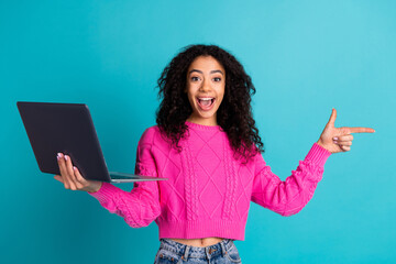 Photo portrait of attractive teen girl hold netbook point empty space dressed stylish pink clothes...