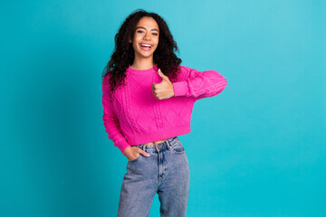 Portrait of nice young girl show thumb up empty space wear pink pullover isolated on turquoise...