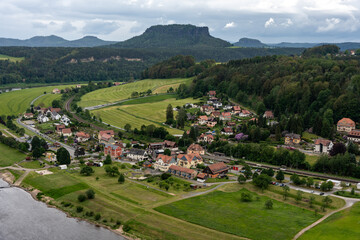 A small town with a river running through it. The houses are small and the town is surrounded by...