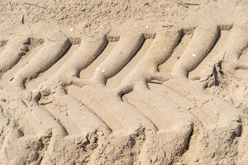 Tire tread marks in beach sand