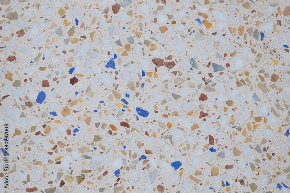 Poster a mosaic tile floor with a variety of colors and textures. the tiles are scattered all over the floo