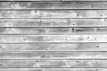 A wooden background with a few small black dots. The background is mostly white and the dots are...