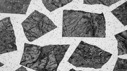 A black and white photo of a stone mosaic with a white background