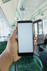 passenger sitting in a bus using his phone.