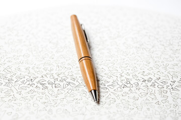 Fototapeta premium Wooden pen on a white background with doodles