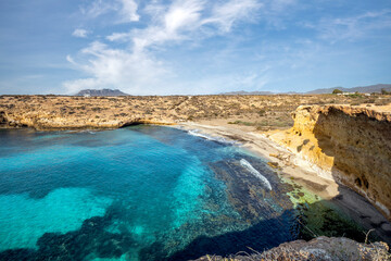 View from above of the Cala Blanca beach of the Puntas de Calnegre regional park in the Region of Murcia, Spain with its crystalline and emerald waters