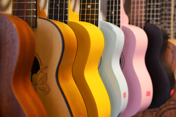 Row of colorful guitars hanging 