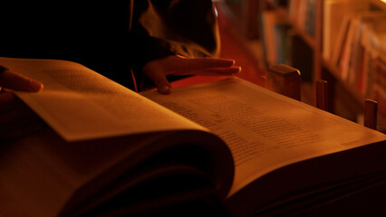 Man reading large mysterious book. Stock footage. Close-up of mysterious man reading ancient...