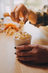 A woman holding a bowl of popcorn