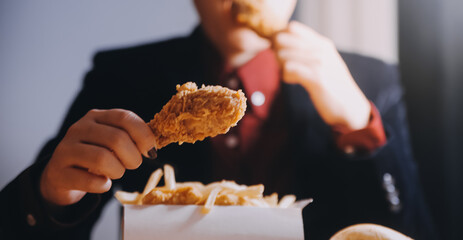 close up focus woman hand hold fried chicken for eat,girl with fast food concept