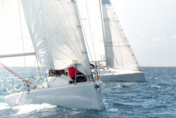 Competitive sailing yachts racing on open sea