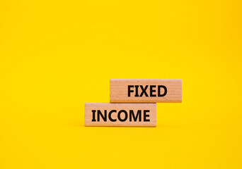 Fixed Income symbol. Concept word Fixed Income on wooden blocks. Beautiful yellow background. Business and Fixed Income concept. Copy space