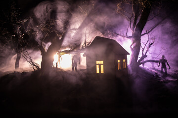 Silhouette of person standing in the dark forest with light. Horror halloween concept.