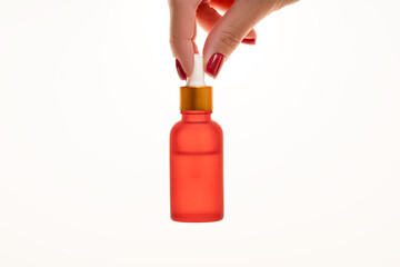 Product presentation, face serum mockup, holding hand a dropper bottle