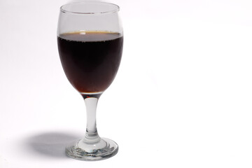 a glass of fizzy cola drink isolated on white