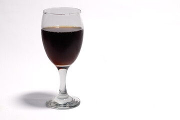 a glass of fizzy cola drink isolated on white