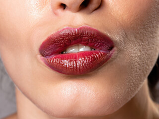 Fototapeta premium lips of a woman giving a kiss, perfect lips, glamour makeup, closeup on lipstick