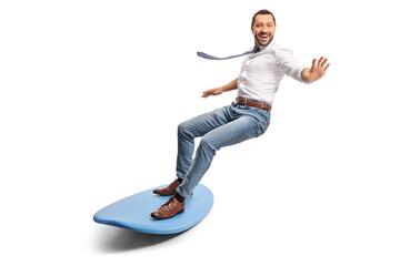 Happy businessman riding a surfboard