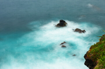 Atlantic ocean coastline on Azores, Portugal. Stones, rocks and water in long exposure. Nature...