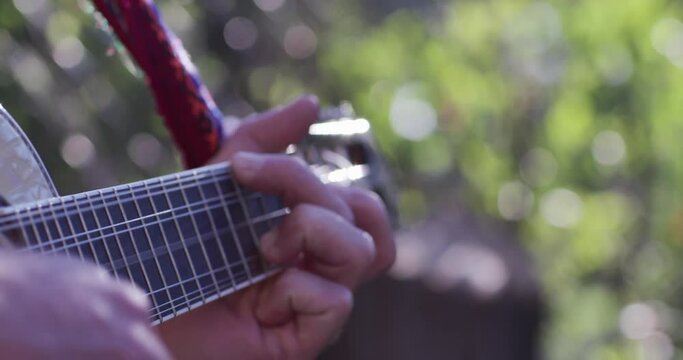 Musician playing the mandolin & lens flare, warm morning light & Bokeh Balls