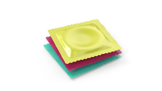 Stack of three different condoms on a white background